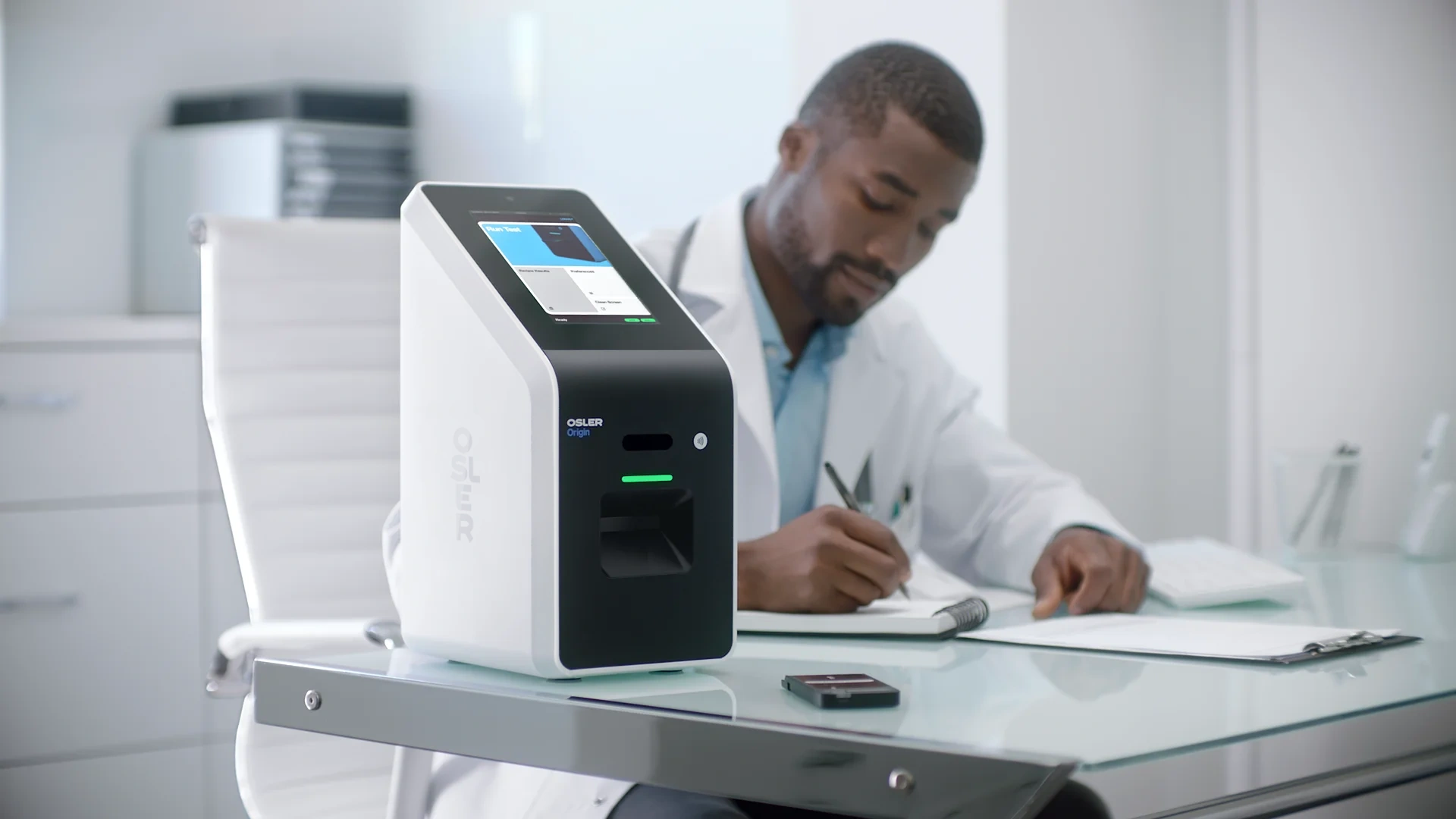 Clinician using the Osler Origin analyser at a desk